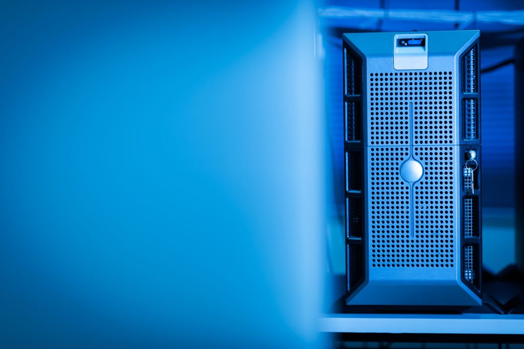 Що таке хмарні сховища і як ними користуватися Close-up of a modern server unit in a blue-lit data center environment.